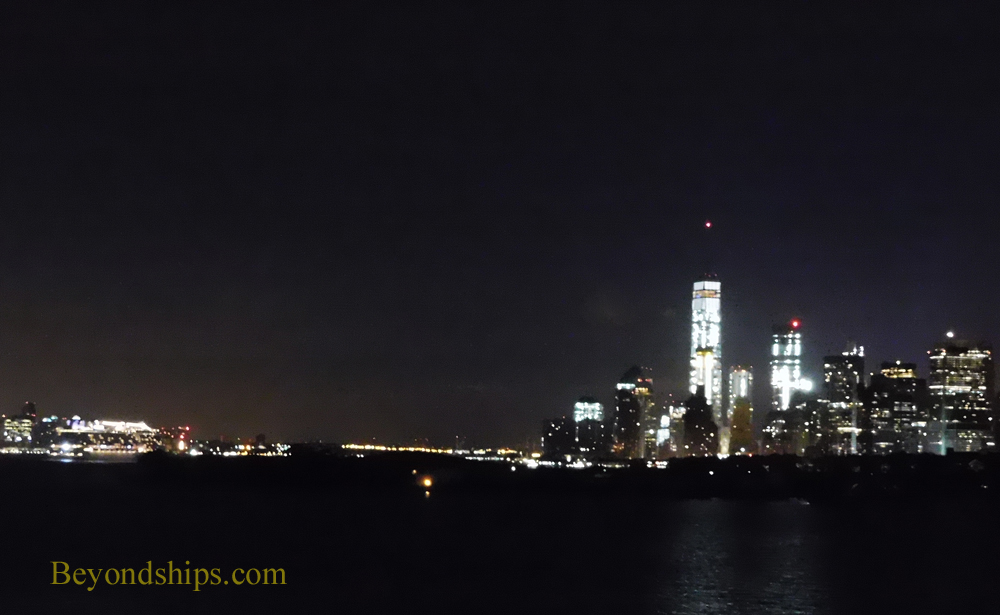 Norwegian Breakaway cruise ship with Manhattan skyline at night